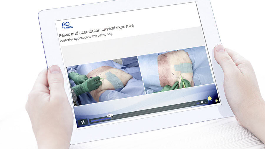 Two hands holding a Tablet: AO videos and learning tools-Digital teaching and learning material at your fingertip